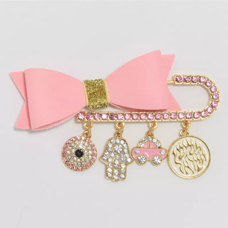 Pink bow baby pin with gold-tone jeweled charm dangles