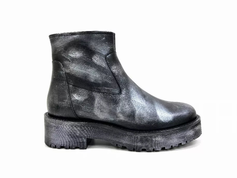 Black ankle booties with metallic leather-look finish and thick lug sole; front 3/4.