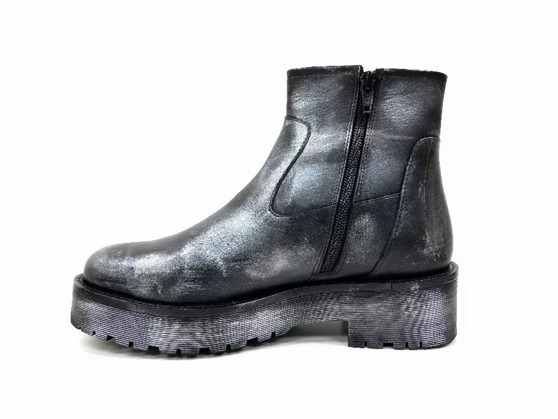 Black ankle booties with side zipper, metallic finish, and chunky lug outsole.
