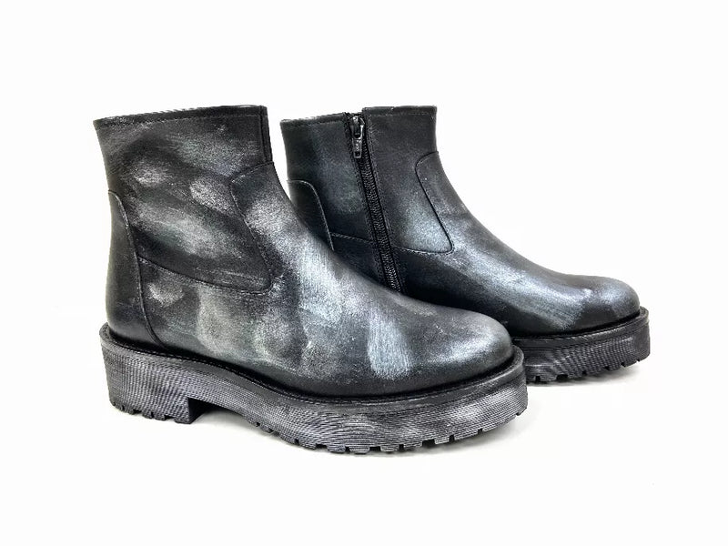 Pair of black metallic ankle booties with wide platform sole and side pull seams.