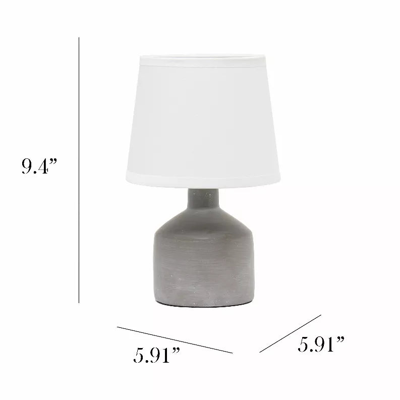 Gray ceramic table lamp with white fabric drum shade and round base