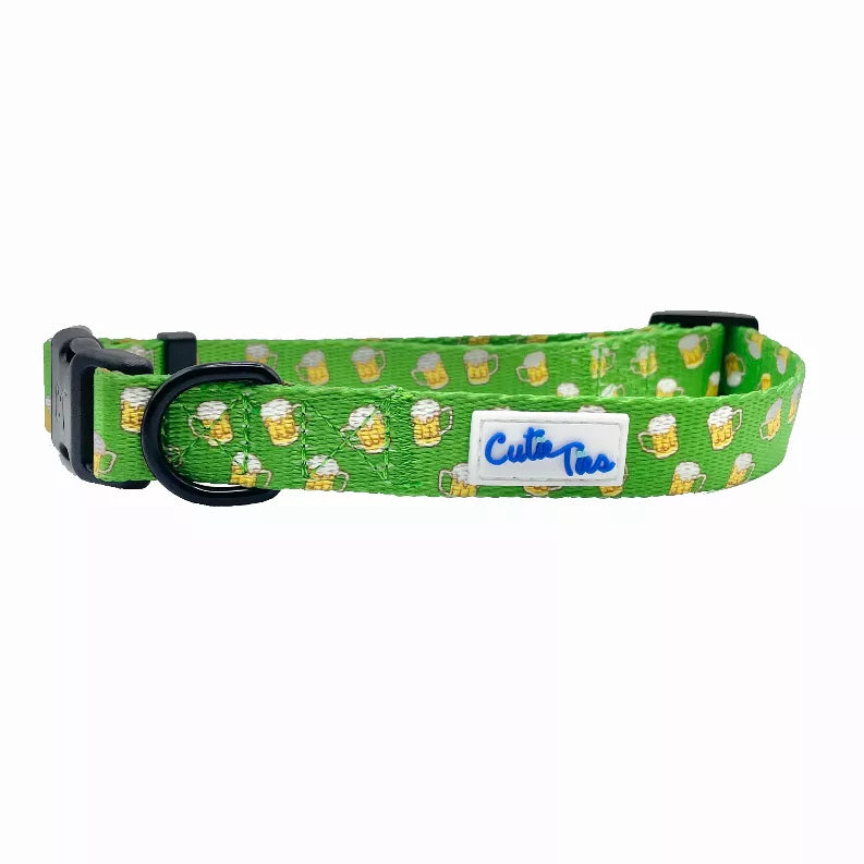 Green dog collar with cactus and dog faces pattern, black buckle and logo tag