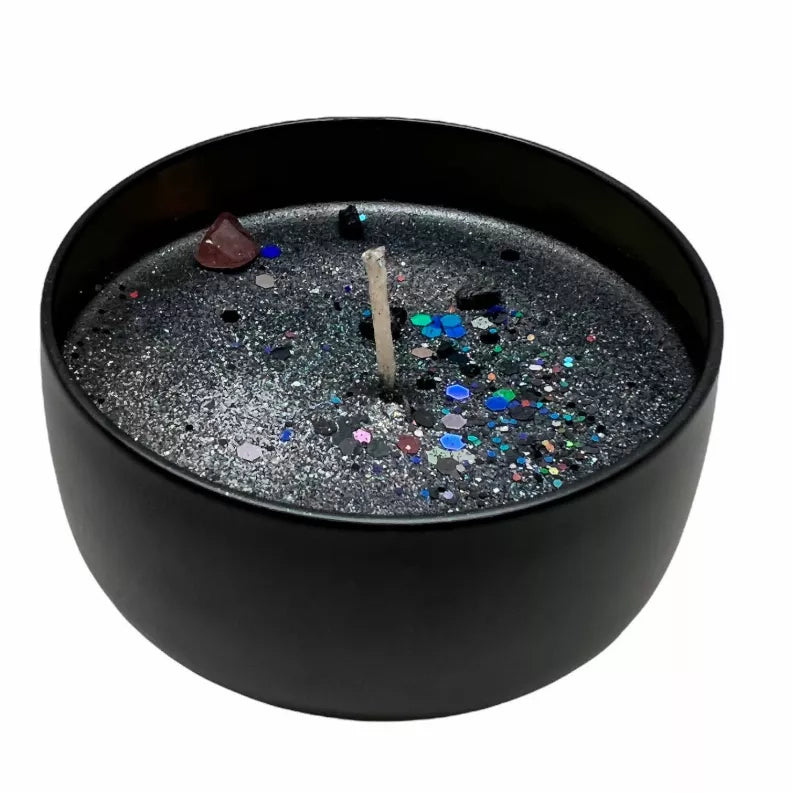 Black protection candle with glitter wax and lit wick in round tin