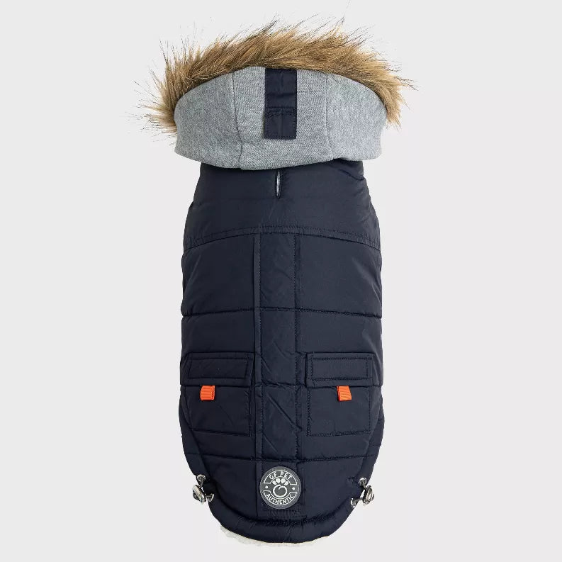 Navy quilted pet parka with gray faux-fur hood, orange logo accents, and clip straps