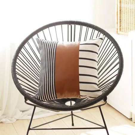 Throw pillow cover with brown panel and black-and-white vertical and horizontal stripes