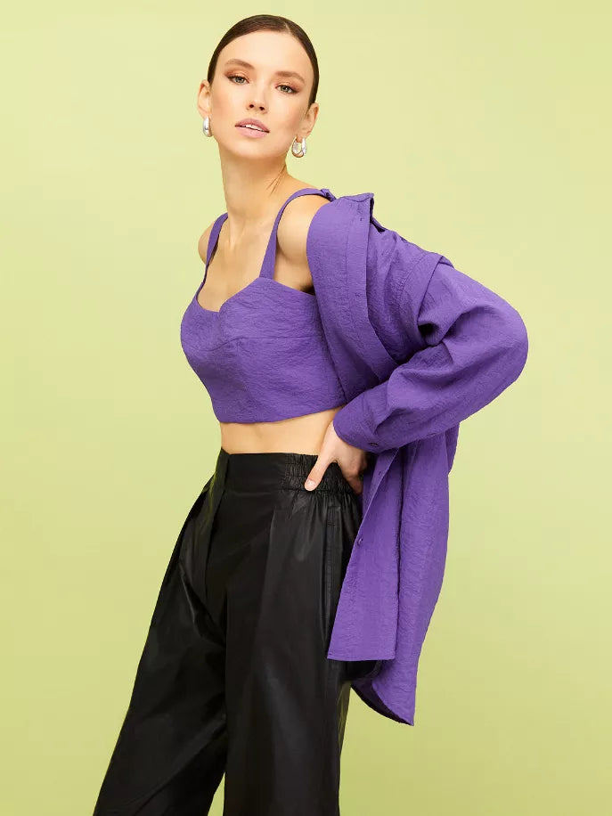 Oversized purple shirt draped open over fitted purple crop top