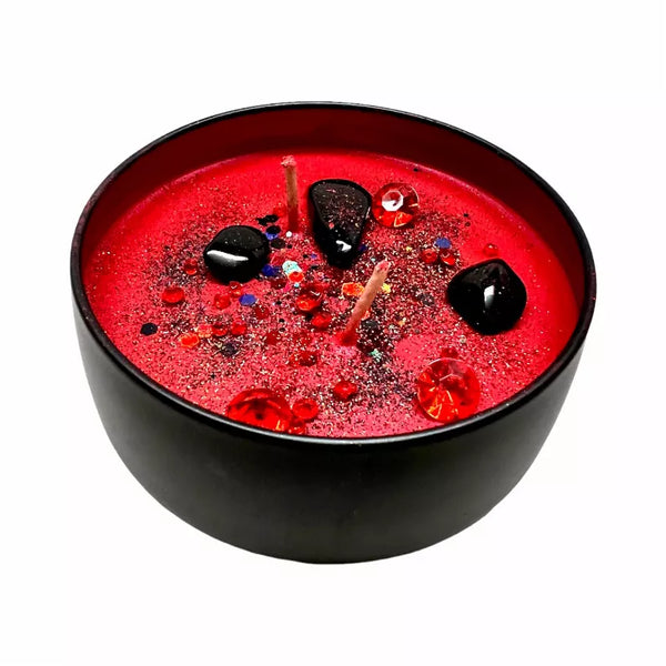 Spiritual offering candle tin with red glitter wax and embedded stones on black lid
