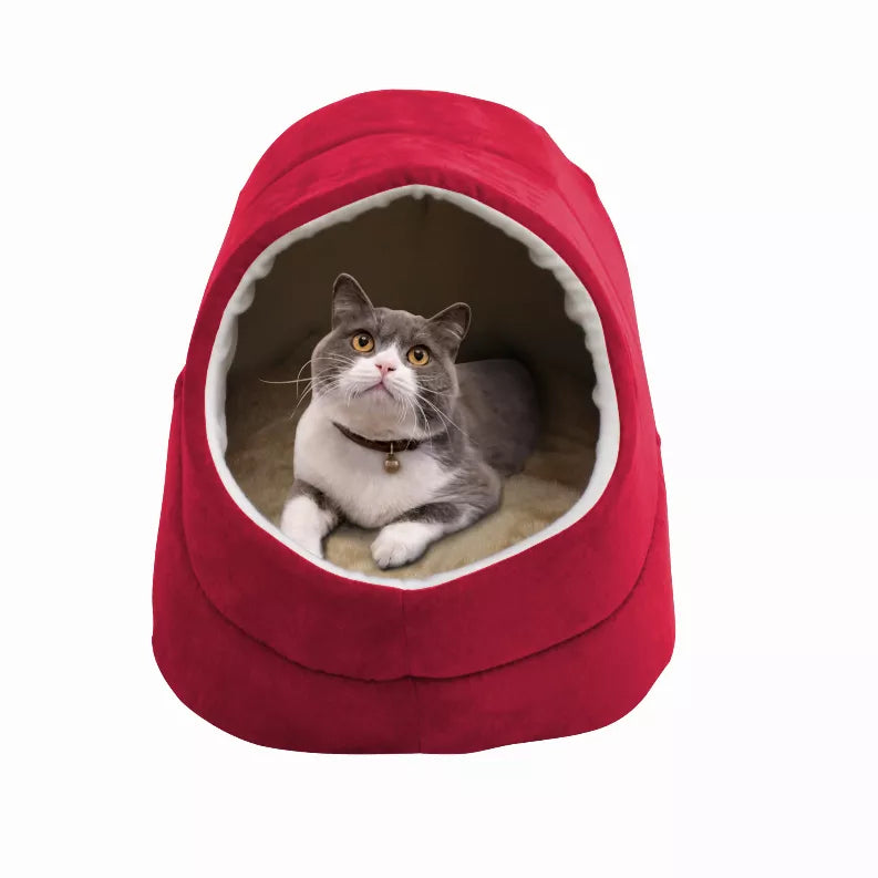 Red cat cave bed with cream-trimmed circular entrance and gray cat resting inside