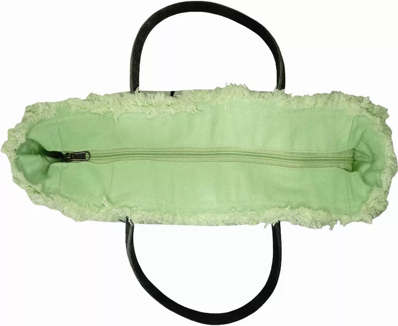 Light green tote bag with black handles and an outer zipper pocket panel.
