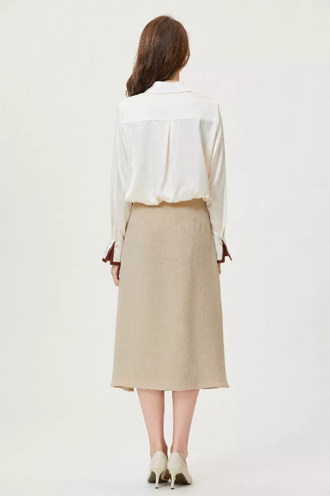 Back view of white silk button shirt with brown collar trim