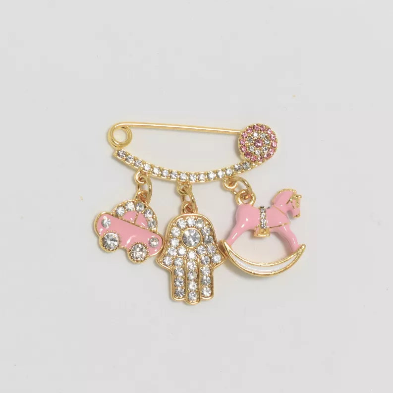 Gold-tone baby pin with pink heart, boot, and hand charms, rhinestone accents
