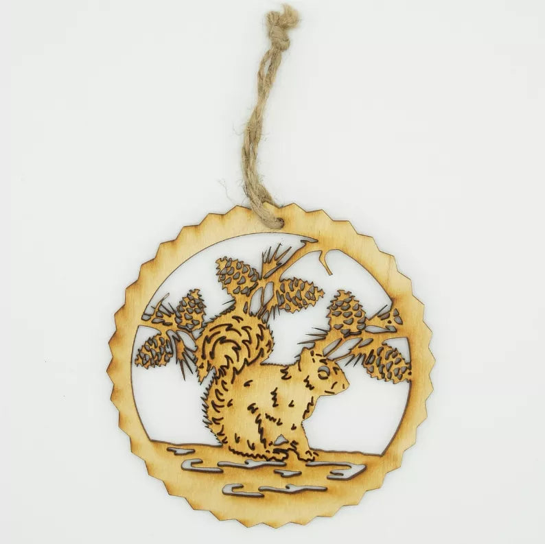 Unfinished squirrel tree ornament with pinecone and pine branch design, wood cutout.