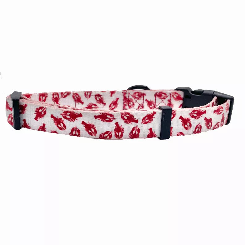 Red lobster-print dog collar with black buckle and adjustable holes, side view