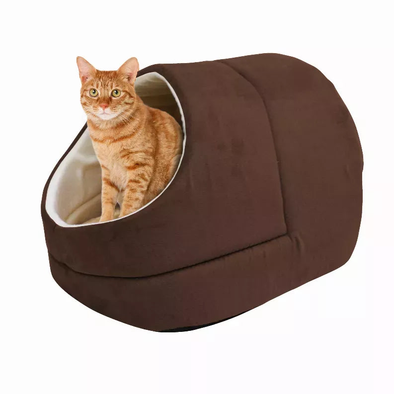 Brown cat cave bed with oval opening and light interior, orange tabby cat sitting inside