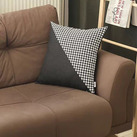 Throw pillow featuring dark gray fabric with white houndstooth diagonal panel
