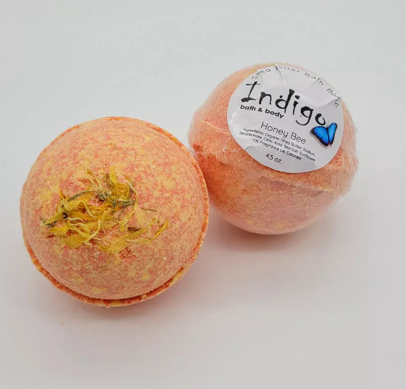 Honey Bee bath bomb with peach-orange round shape and dried flower accents