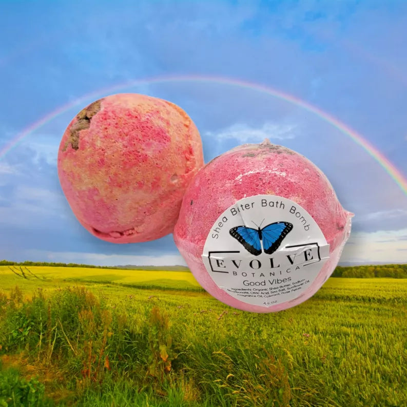 Pink and magenta round bath bombs with EVOLVE label, includes one butterfly design