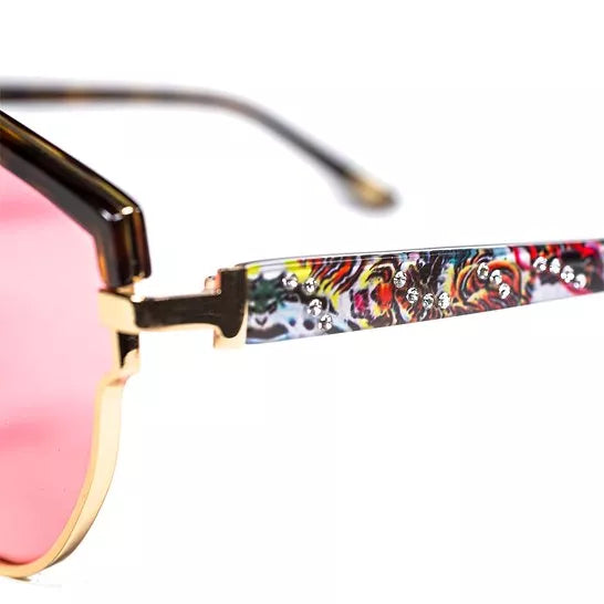 Close-up of sunglasses hinge and colorful tiger-print temple arm with lens edge.