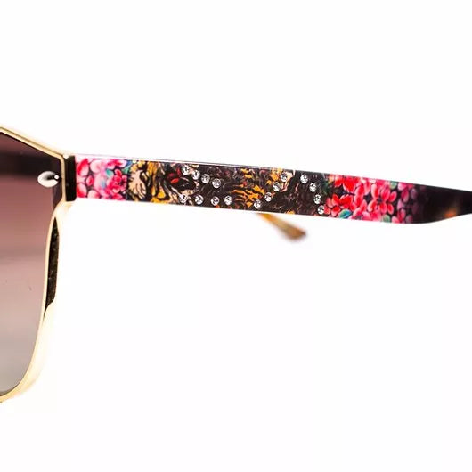 Close-up of sunglasses top rim with colorful tiger-print frame detail.