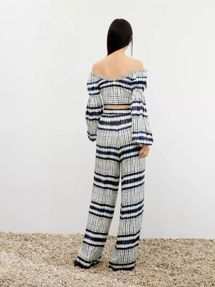 Back view of cream and navy striped off-shoulder crop top with long sleeves