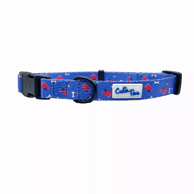 Blue dog collar with patriotic pattern and black buckle; logo patch on strap