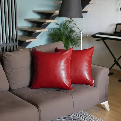 Pair of red faux leather square throw pillows with glossy finish