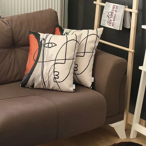 Printed throw pillow cover with abstract face line art in black and orange on white