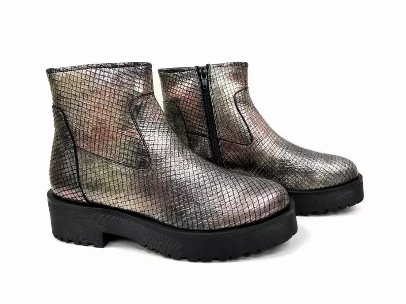 Pair of metallic silver ankle booties with black lug soles and side zipper detail