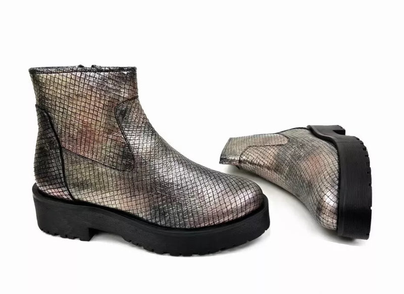 Metallic silver ankle bootie with black lug heel and side elastic panels