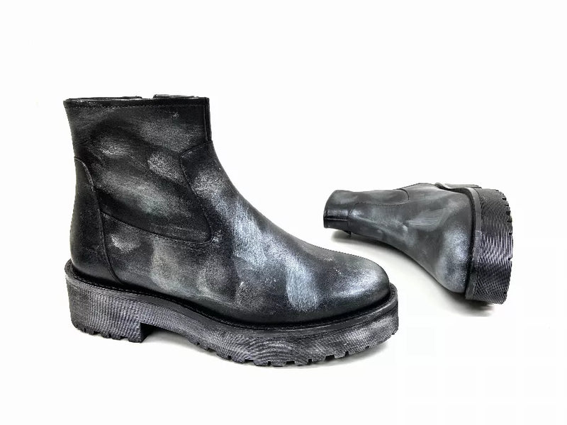 Black ankle bootie with side zipper and stacked lug heel, shiny leather look