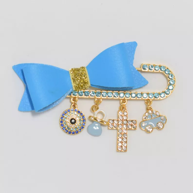 Blue ribbon bow hair pin with gold-tone base and dangling rhinestone cross and charms