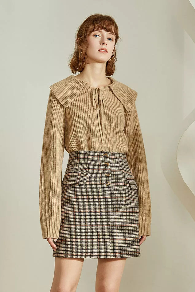 Brown micro-check mini skirt with front flap and two button details at waist.