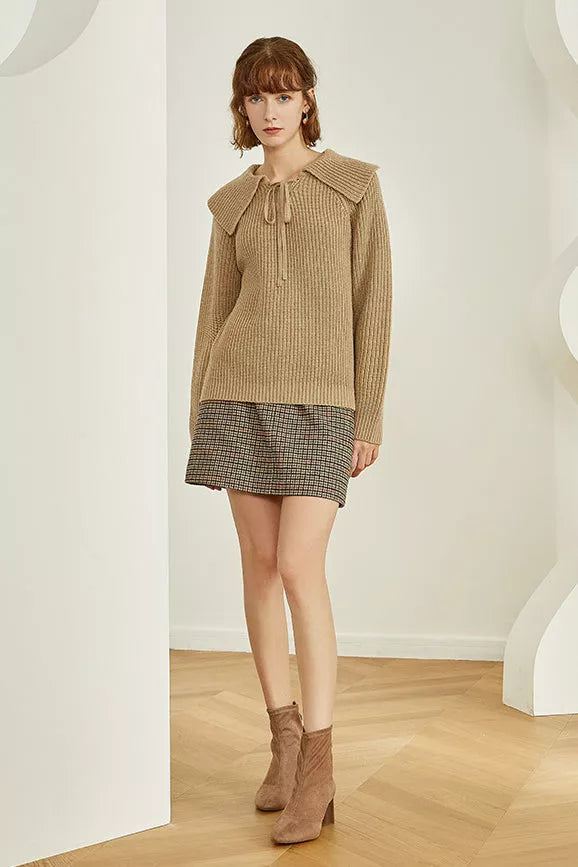 Gingham mini skirt with button front and side slit, dark check pattern.