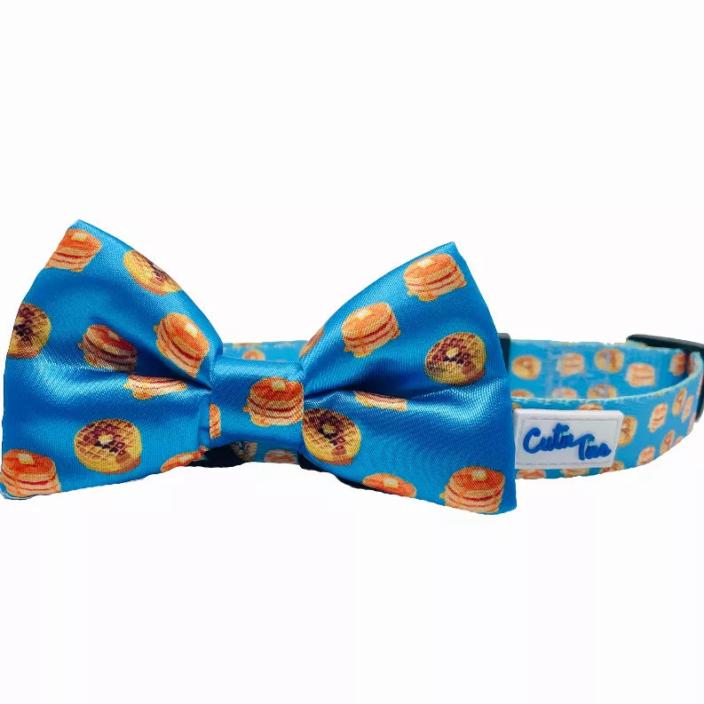 Blue dog collar with bow and repeating food print, close-up angle