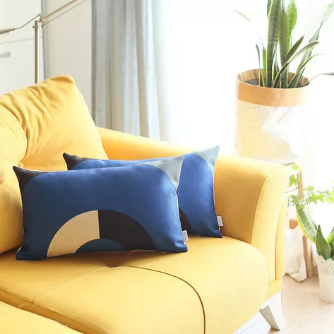Printed throw pillow covers: blue, black, and cream arch design on couch