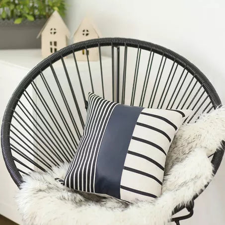 Pillow cover front with navy-blue panel and black-and-white vertical stripes bordered by horizontal stripes