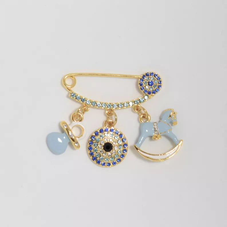 Gold-tone baby pin with dangling blue evil-eye, heart, and rocking horse charm