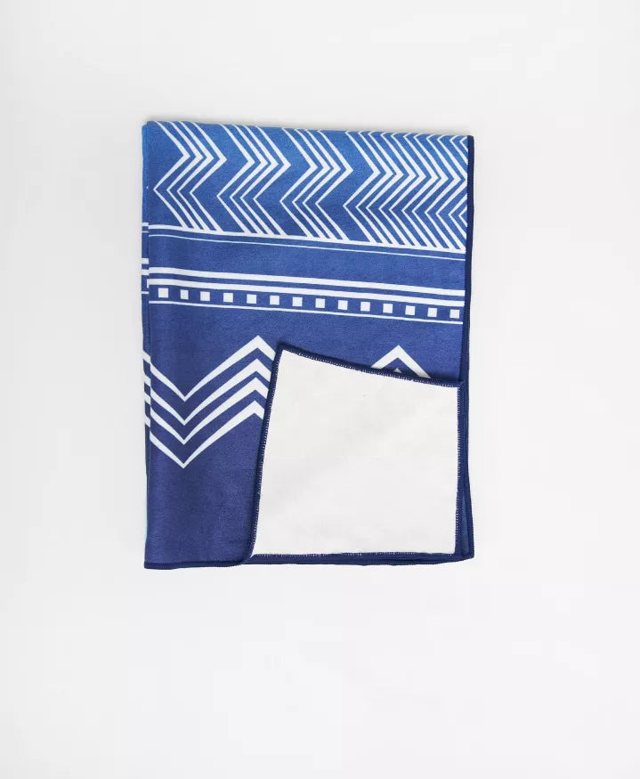 Yoga towel with blue zigzag arrows and white panel, folded