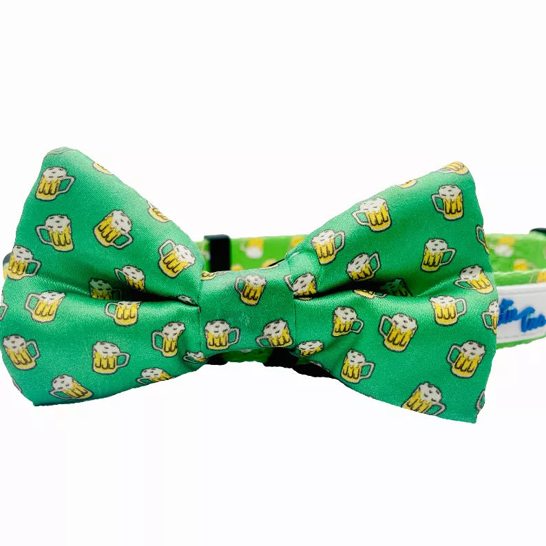 Green dog collar with sewn bow tie and cute dog treat pattern