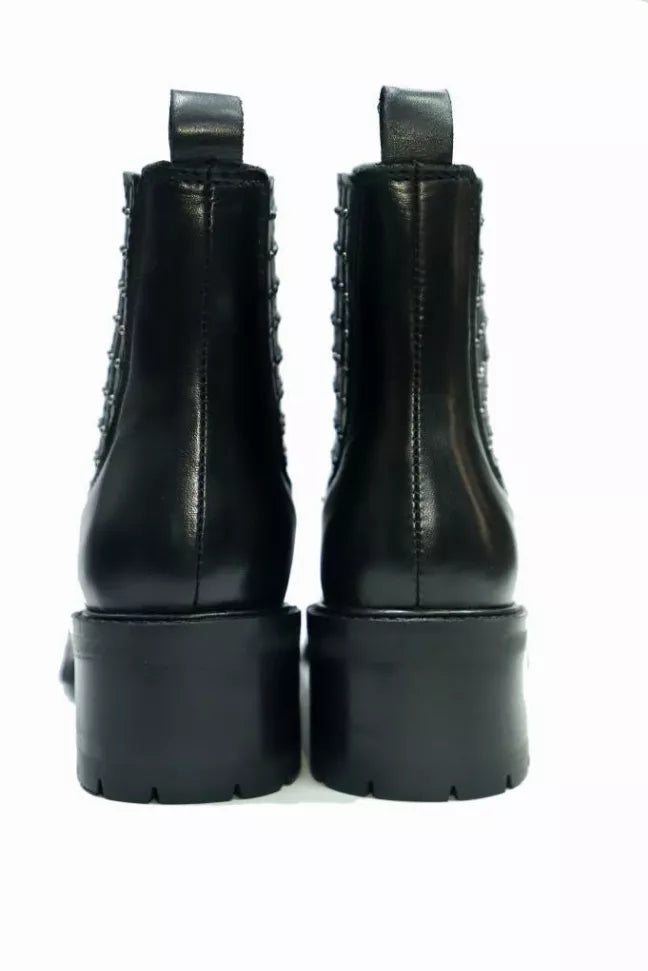 Black Chelsea boots, rear view with chunky platform heels and lug soles
