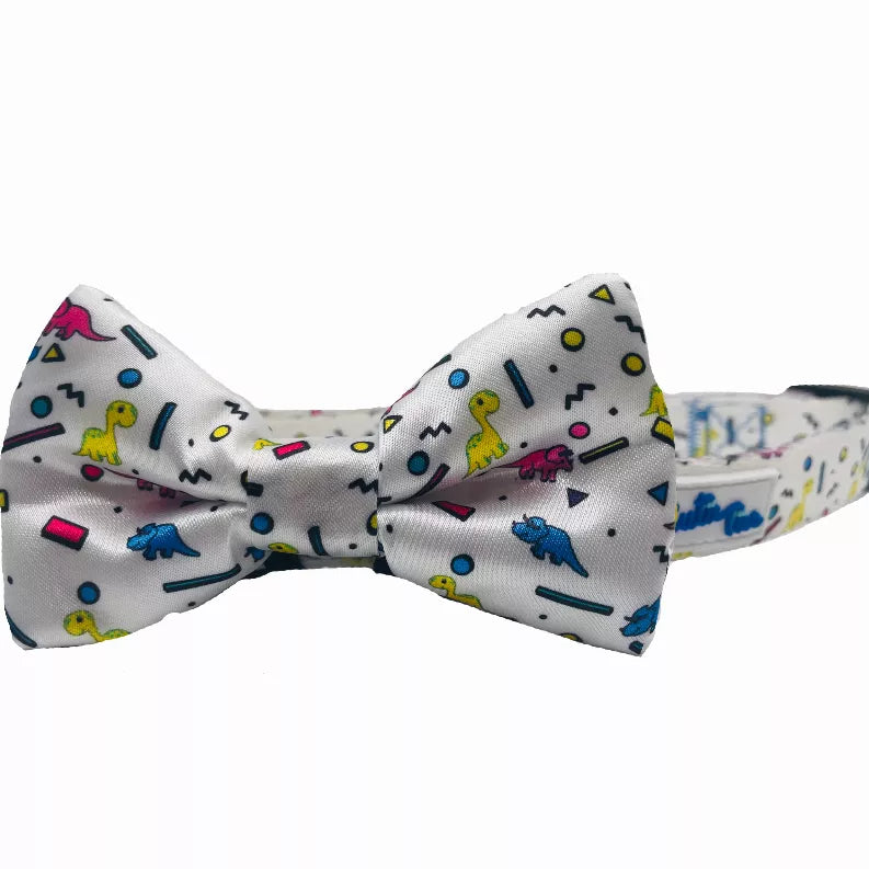 Dog collar bow tie attachment in light gray with colorful dinosaur print