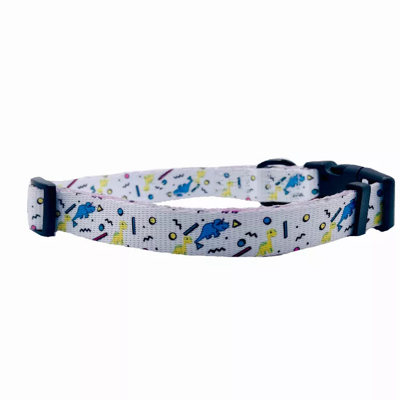 Dog collar side view with light gray dinosaur-patterned strap and black hardware