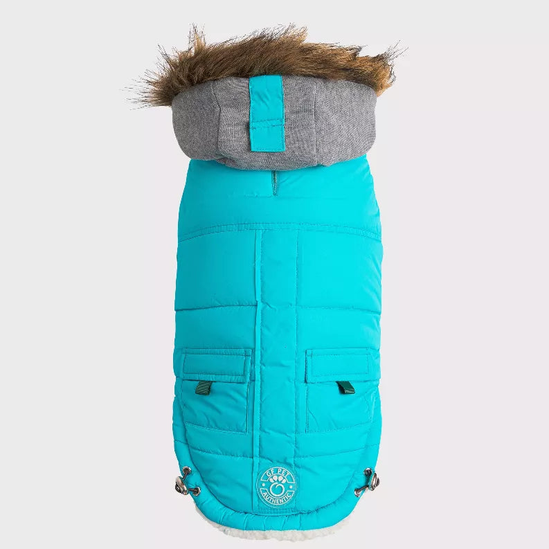 Turquoise pet winter parka with gray hood and faux-fur trim, front logo badge