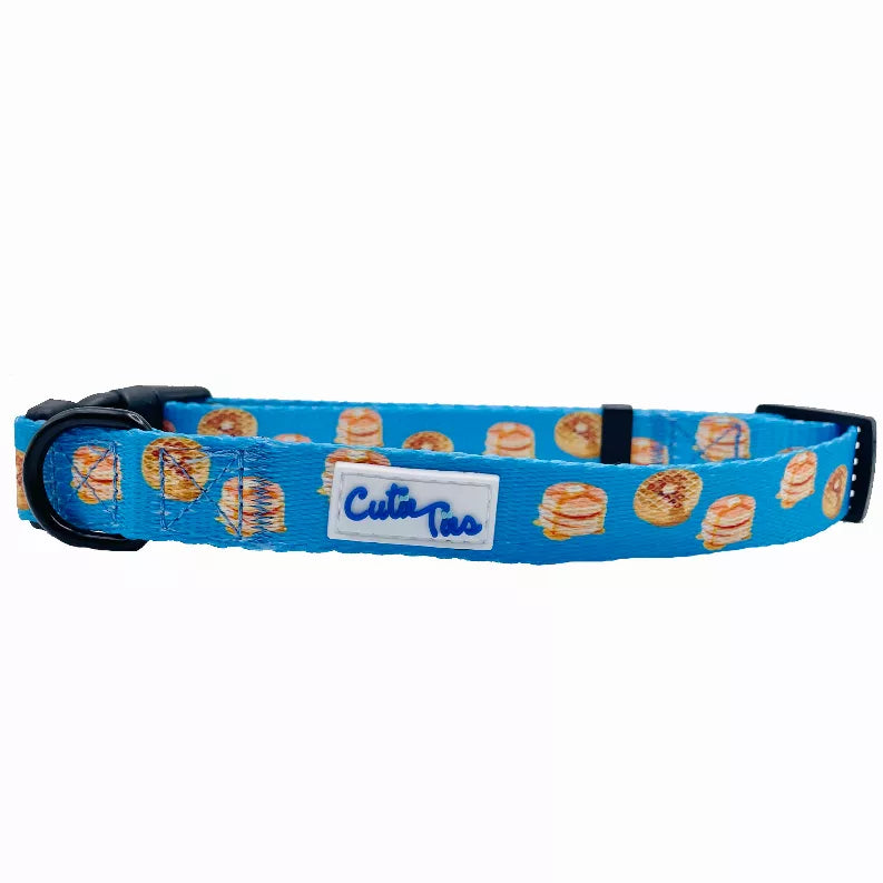 Blue fabric dog collar with hamburger print, black buckle, and Cutie Ties label