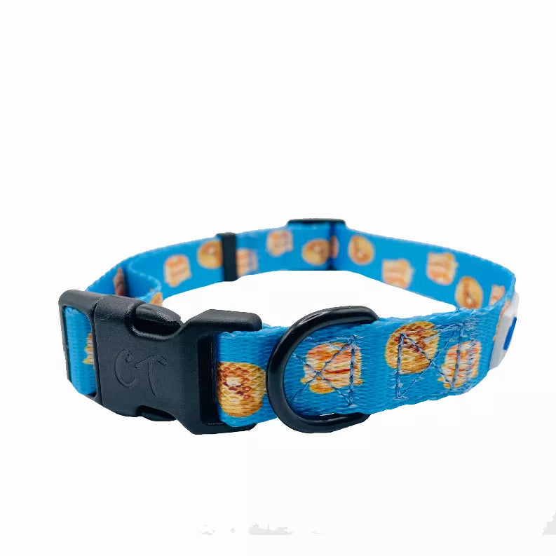 Blue dog collar with hamburger pattern, black buckle clasp, and round metal ring