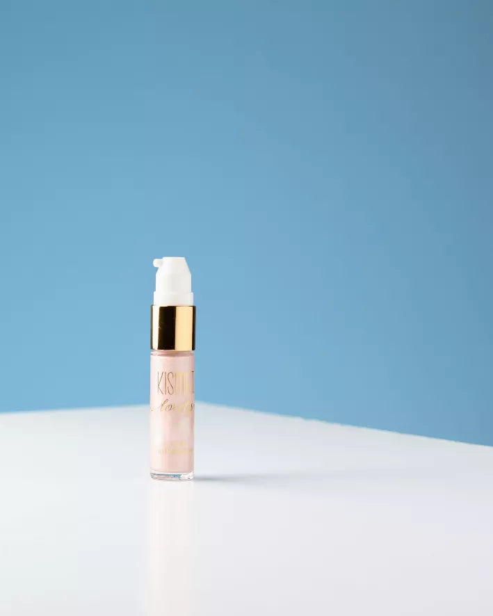 Liquid illuminator bottle with white pump and light rose-pink glossy serum