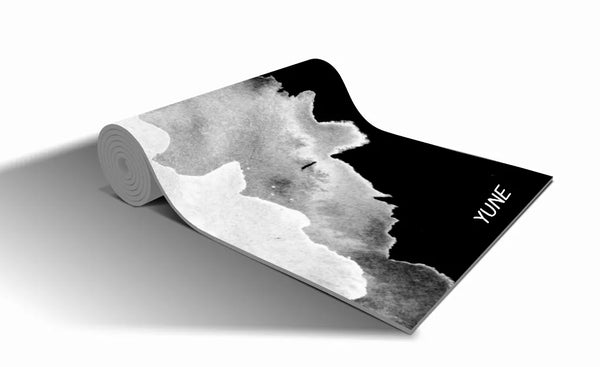 Black yoga mat with gray abstract design and YUNE logo