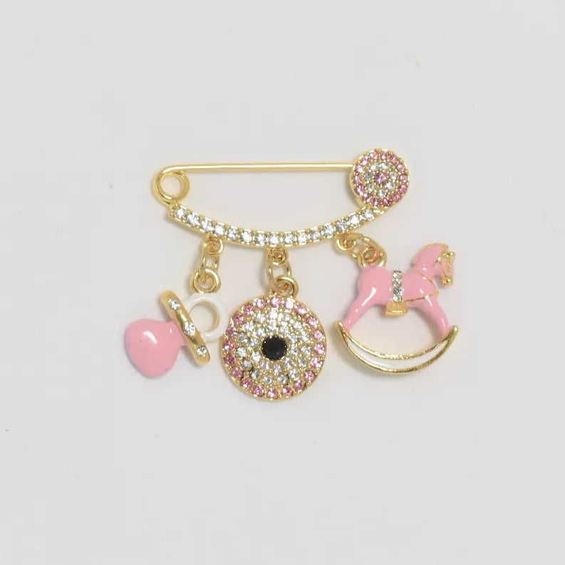 Gold baby pin with pink heart, key, round glitter charm, and rocking horse dangle