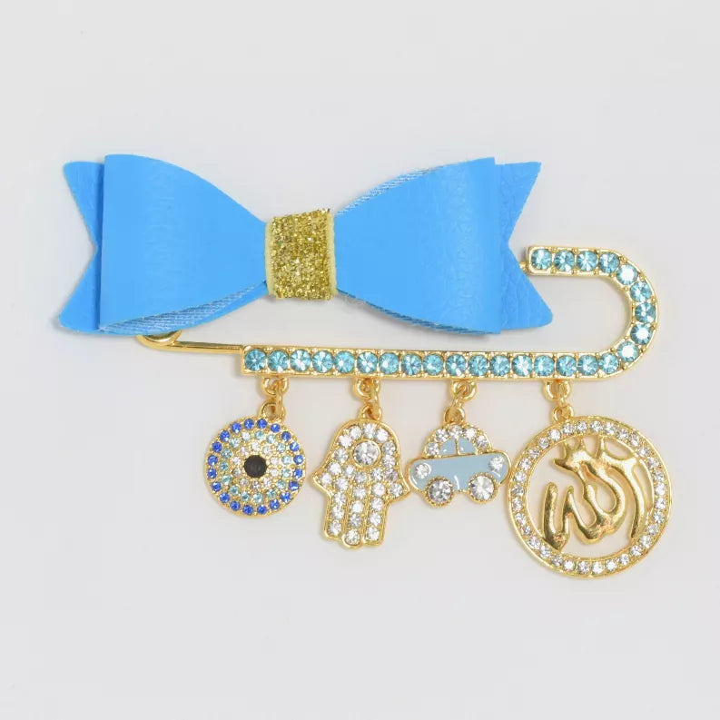 Baby pin set with blue bow, gold-tone safety pin and dangling charm letters and icons