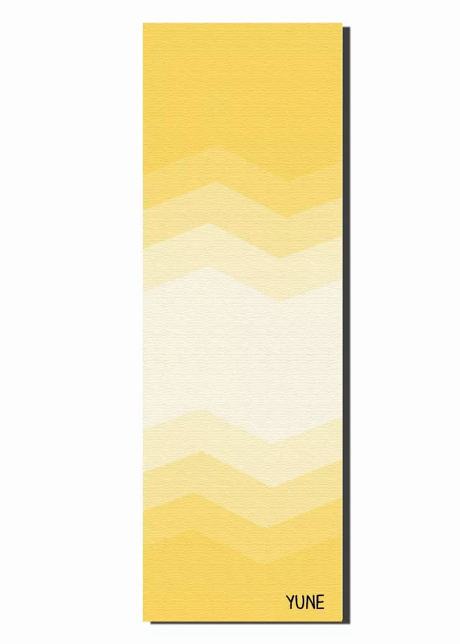 Yoga mat rectangle with zigzag chevron pattern in yellow and cream tones, YUNE logo bottom